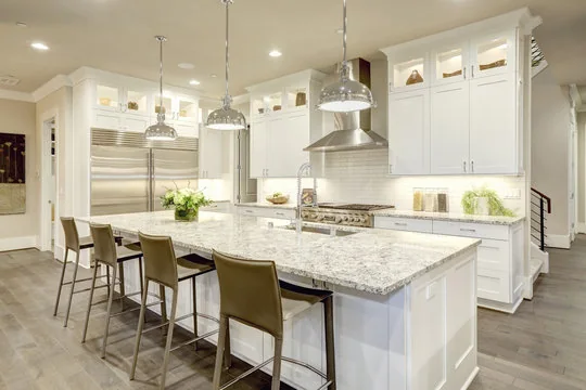 White Shaker kitchen with granite island